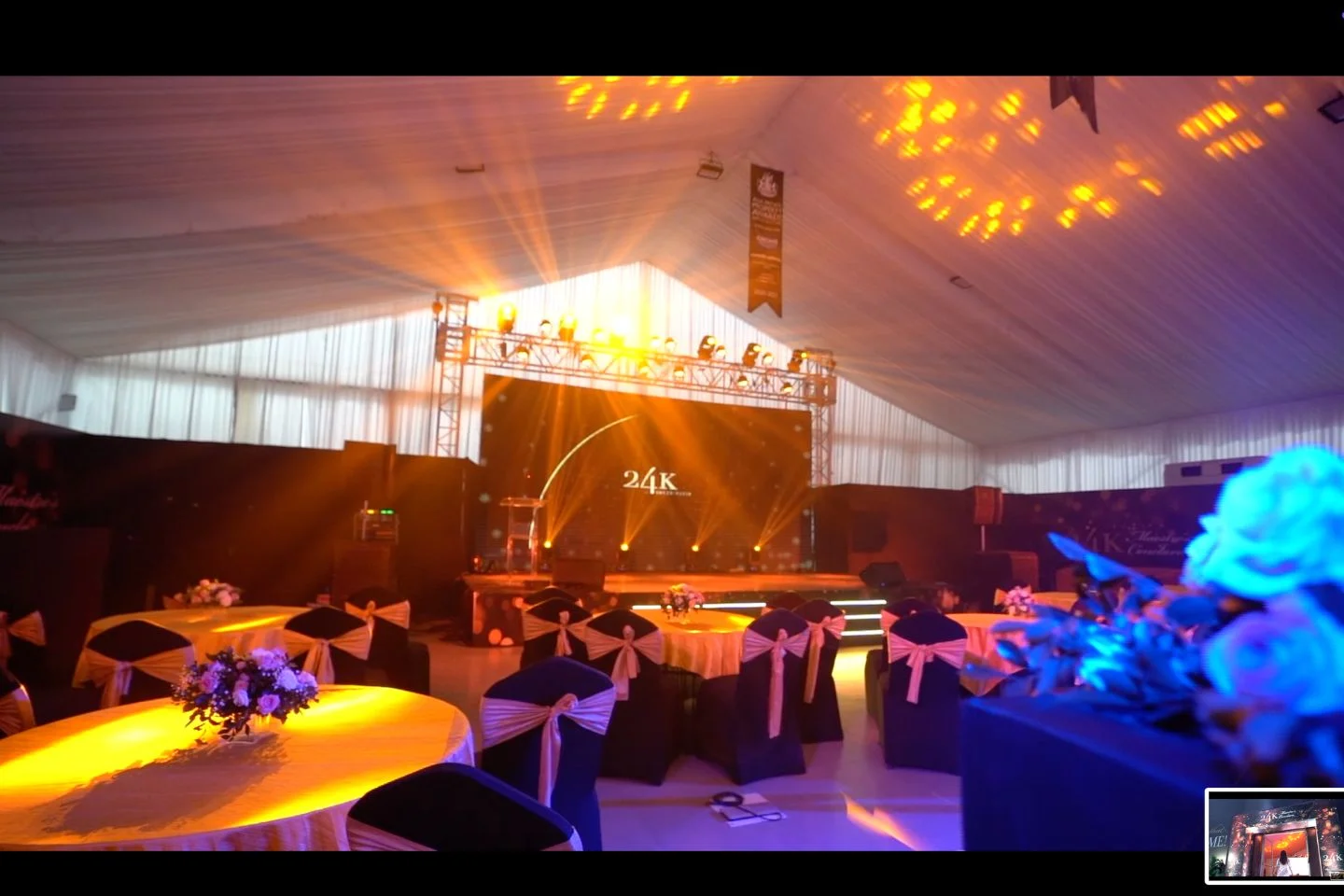 Corporate event venue with stage lighting and banquet seating